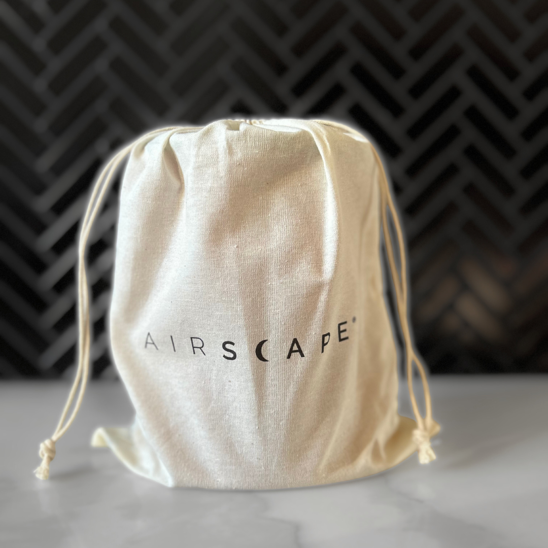 Airscape coffee canister in its pouch on a kitchen marble top.