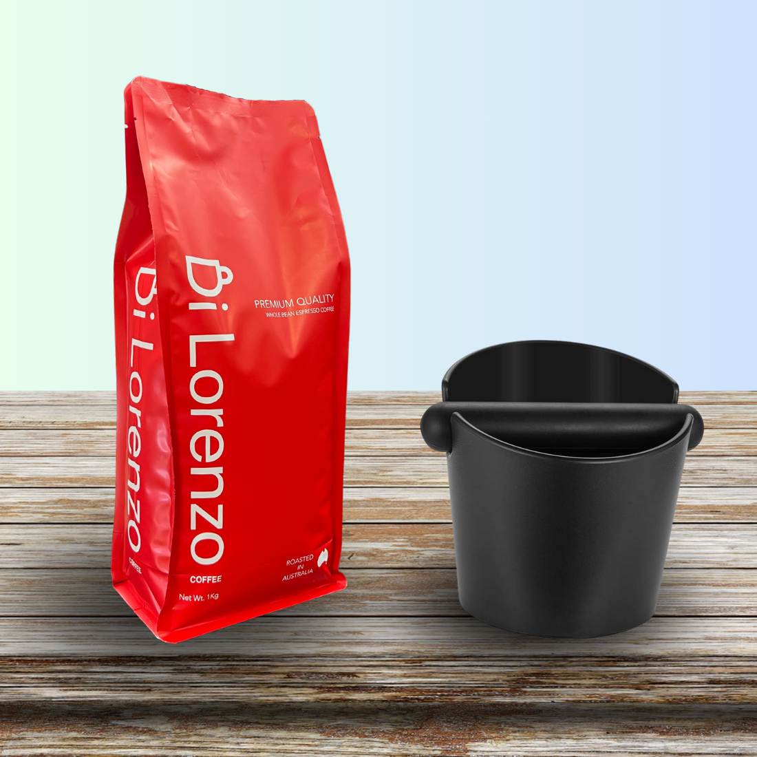 Premium quality Di Lorenzo Coffee beans in a red package on a wooden surface next to a black knock box, for Di Lorenzo's official website, emphasizing fresh roasted coffee from Australia
