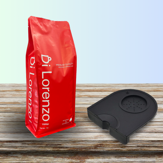 A vibrant red bag of Di Lorenzo Coffee displaying premium quality and roasted in Australia, placed on a rustic wooden surface alongside a black espresso tamper mat, ideal for coffee aficionados, for the Di Lorenzo official website.