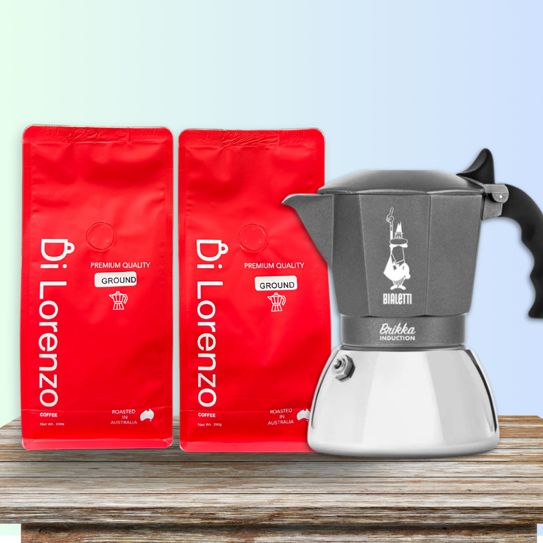 Twin red bags of Di Lorenzo premium quality ground coffee specific for Moka stovetop,  flank a classic grey Bialetti Brikka induction stovetop espresso maker, all presented on a textured wooden surface with a gradient blue sky background.
