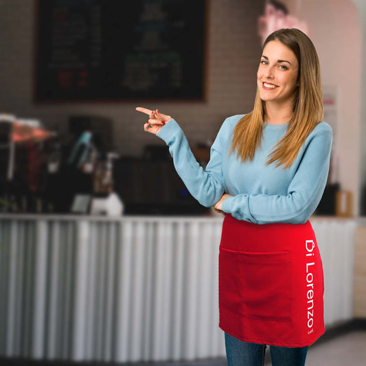 A blond beatiful classic woman wearinga Di Lorenzo red apron with the di lorenzo logo and the red cup